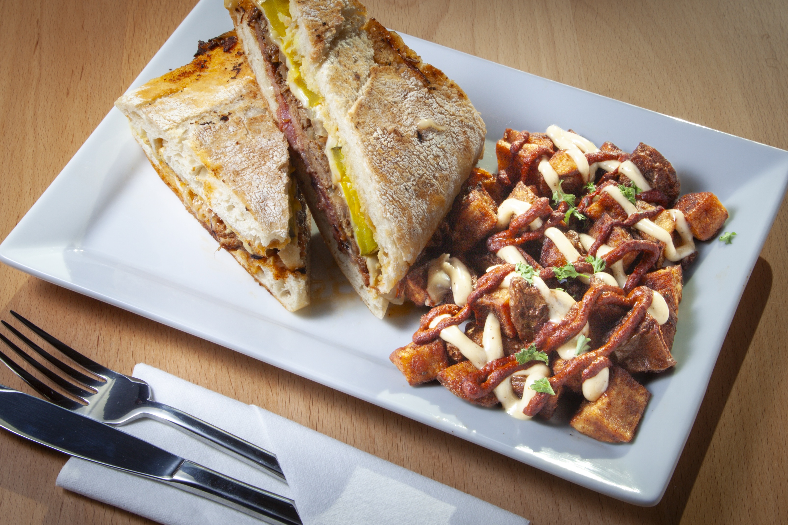 Crispy fried croquettes served on a white plate with roasted garlic aioli dipping sauce at DeWolf Brewing, Victor NY