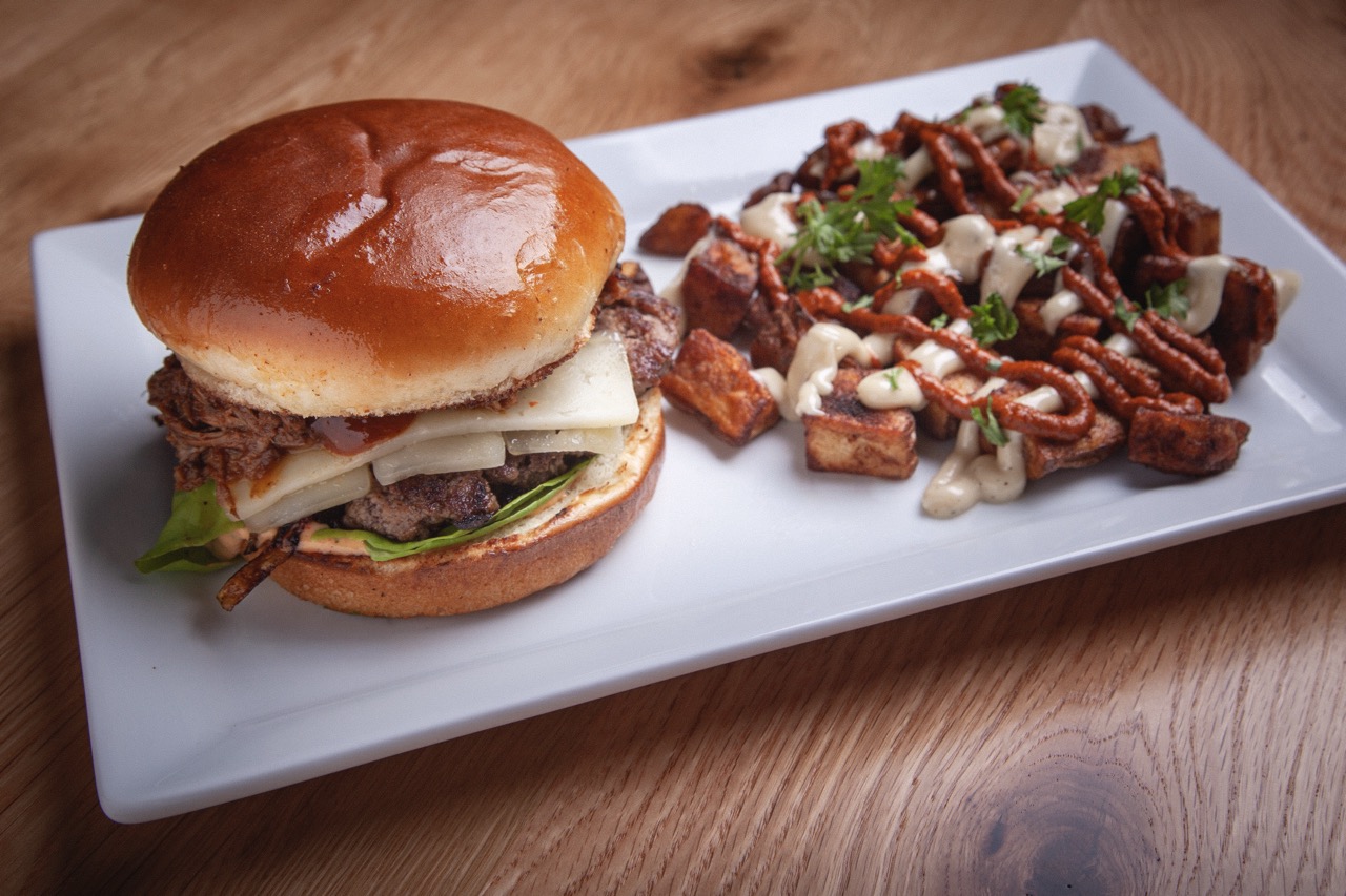 Crispy fried croquettes served on a white plate with roasted garlic aioli dipping sauce at DeWolf Brewing, Victor NY