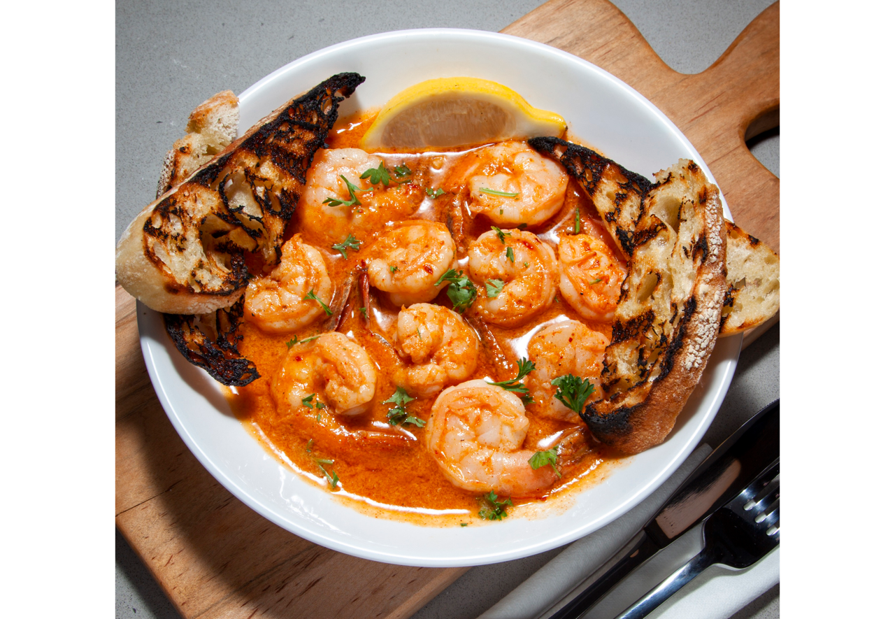 Crispy fried croquettes served on a white plate with roasted garlic aioli dipping sauce at DeWolf Brewing, Victor NY
