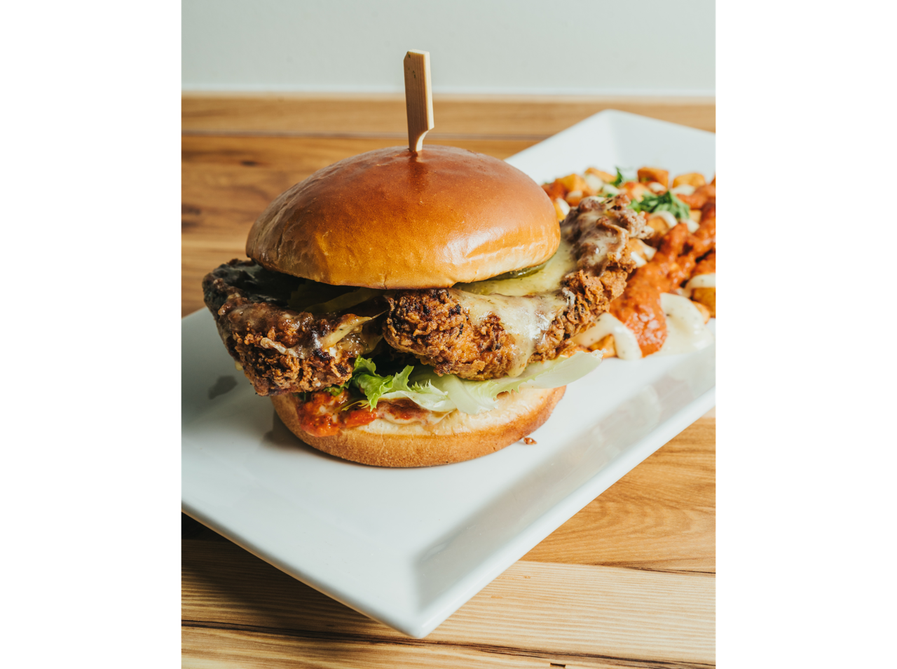 Crispy fried croquettes served on a white plate with roasted garlic aioli dipping sauce at DeWolf Brewing, Victor NY
