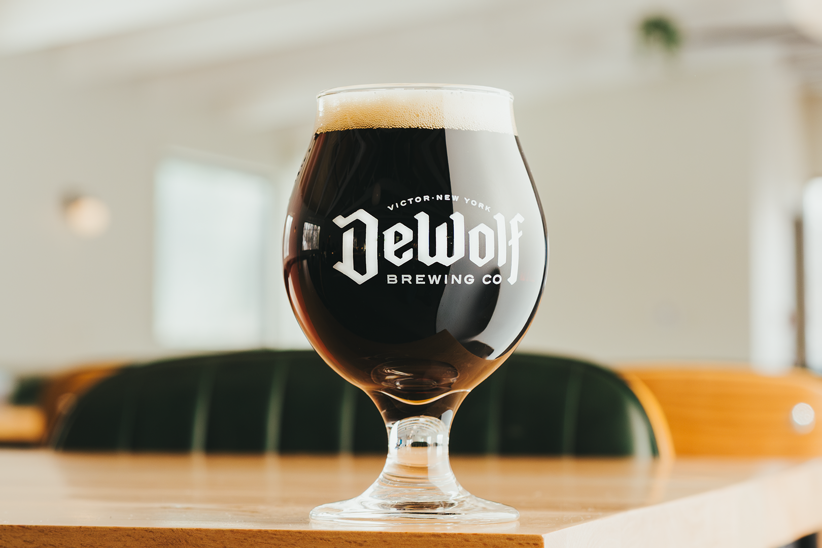 A dark, smooth pour of After Hours Munich Dunkel lager with a creamy tan head in a DeWolf Brewing Co. glass, Victor New York
