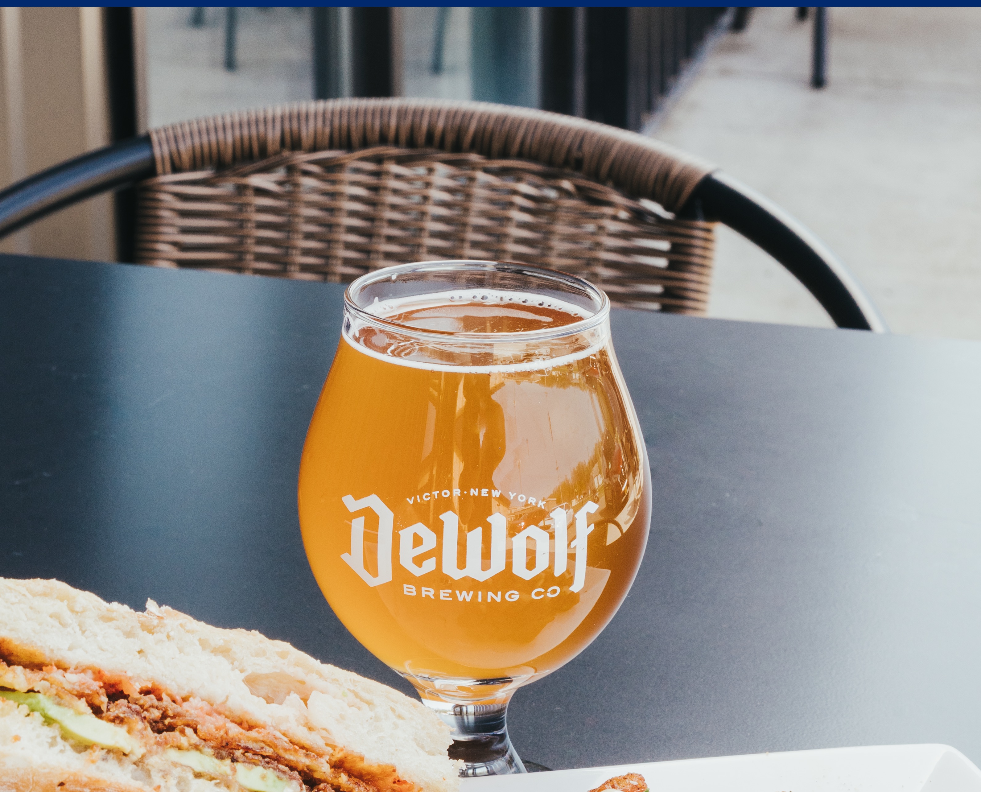 Glass of Belgian-style saison at DeWolf Brewing in Victor, NY, a bright golden beer with a light head, crisp and effervescent with spicy and citrus notes.
