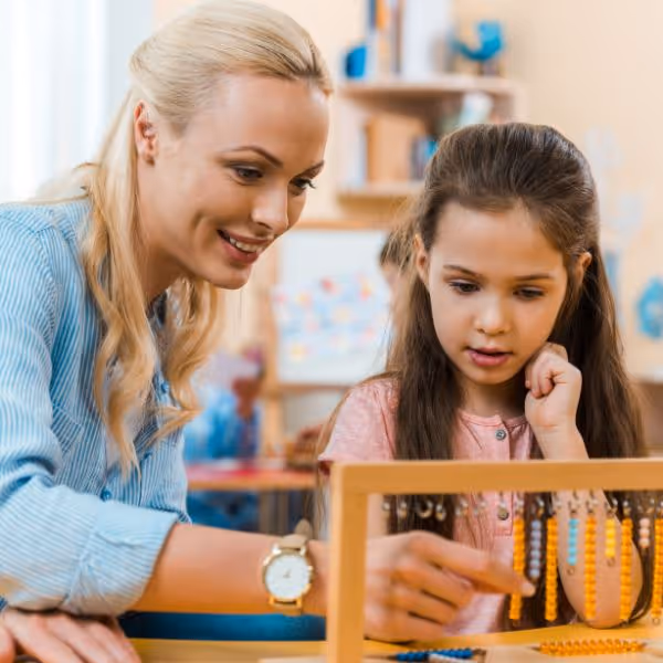 Teacher helping student in class.