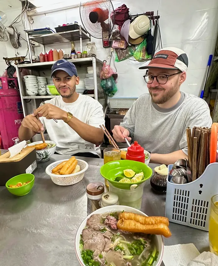 Félix Meens in Vietnam enjoying a bowl of Pho with friends.