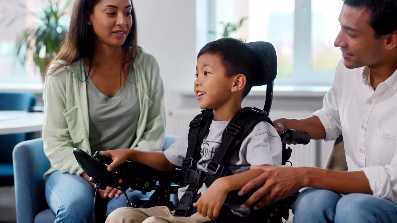 Parents and child speaking with a professional during a family support conversation.
