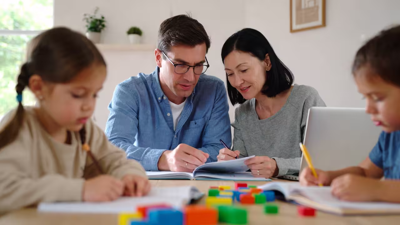 Family completing forms together while supporting a child’s learning and development.