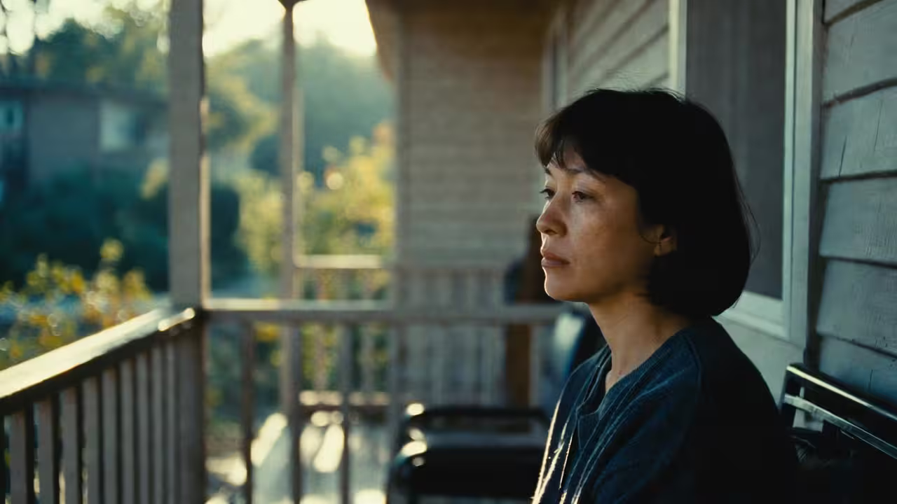 Caregiver taking a quiet moment of reflection while standing near a window or porch.