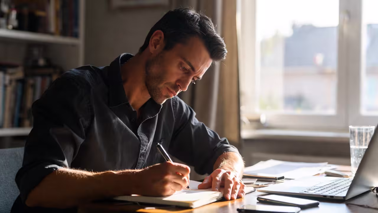 Parent reviewing notes while looking for the right specialist after a child’s diagnosis.