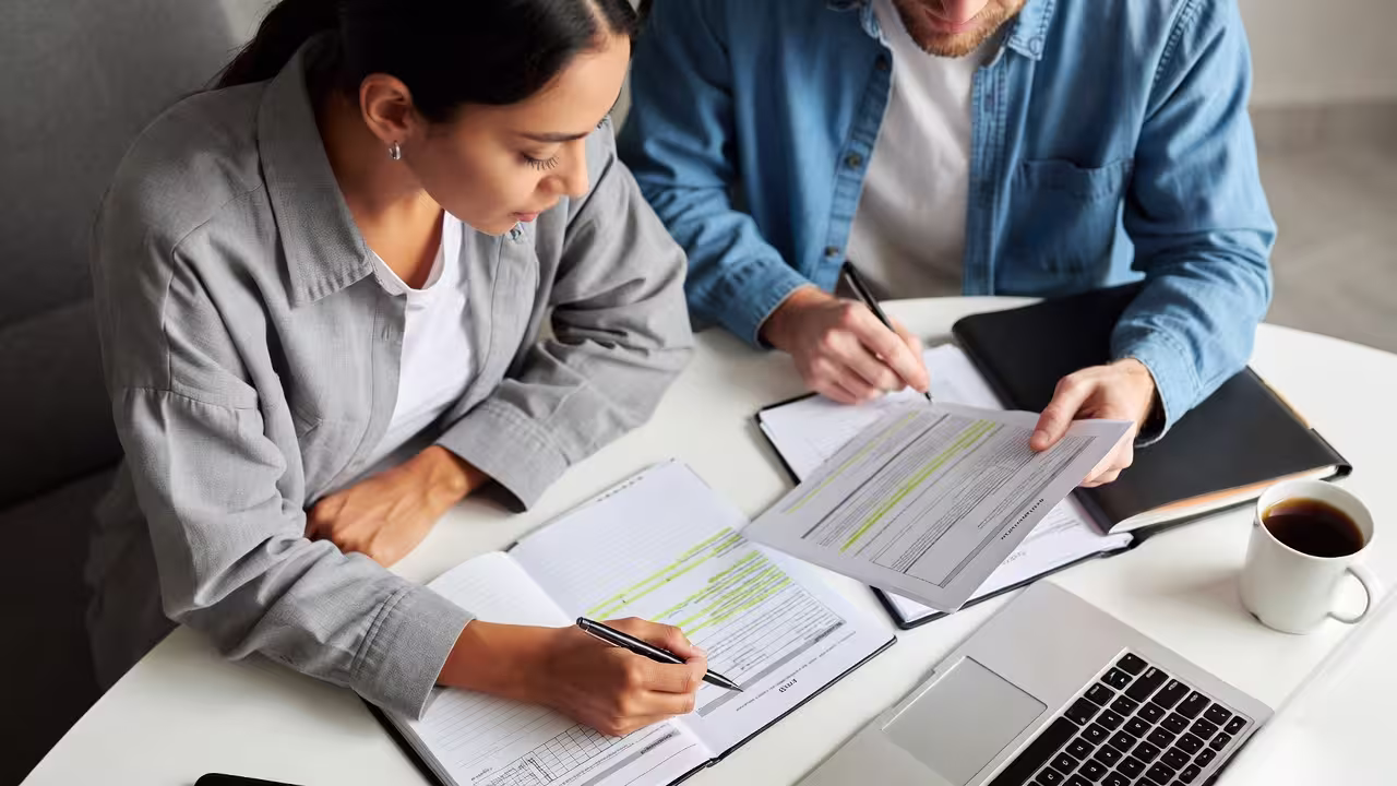 Parent reviewing IEP and 504 paperwork with notes on a table
