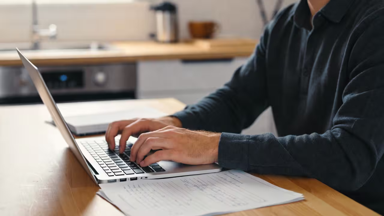 Father at desk studying school documents IEP or 504 Plan