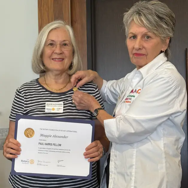Glenys Parton presenting Maggie Alexander with her Paul Harris Fellow award