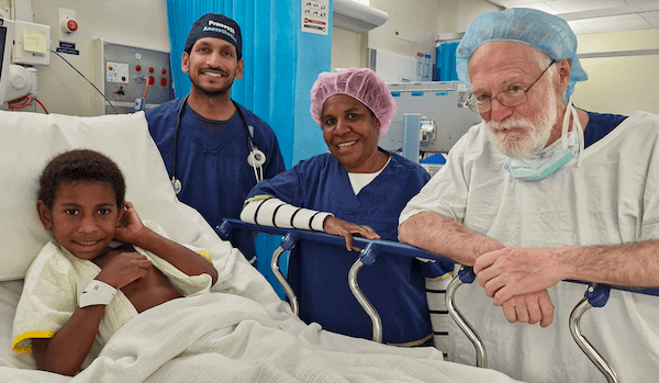 Child patient surrounded by docotrs