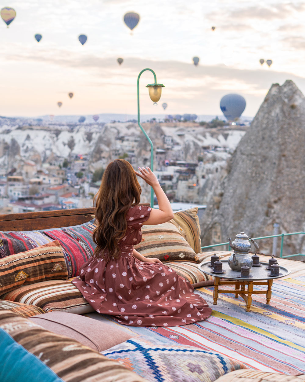 Hot air balloons over the rock formations of Cappadocia at sunrise, captured during a luxury travel shoot
