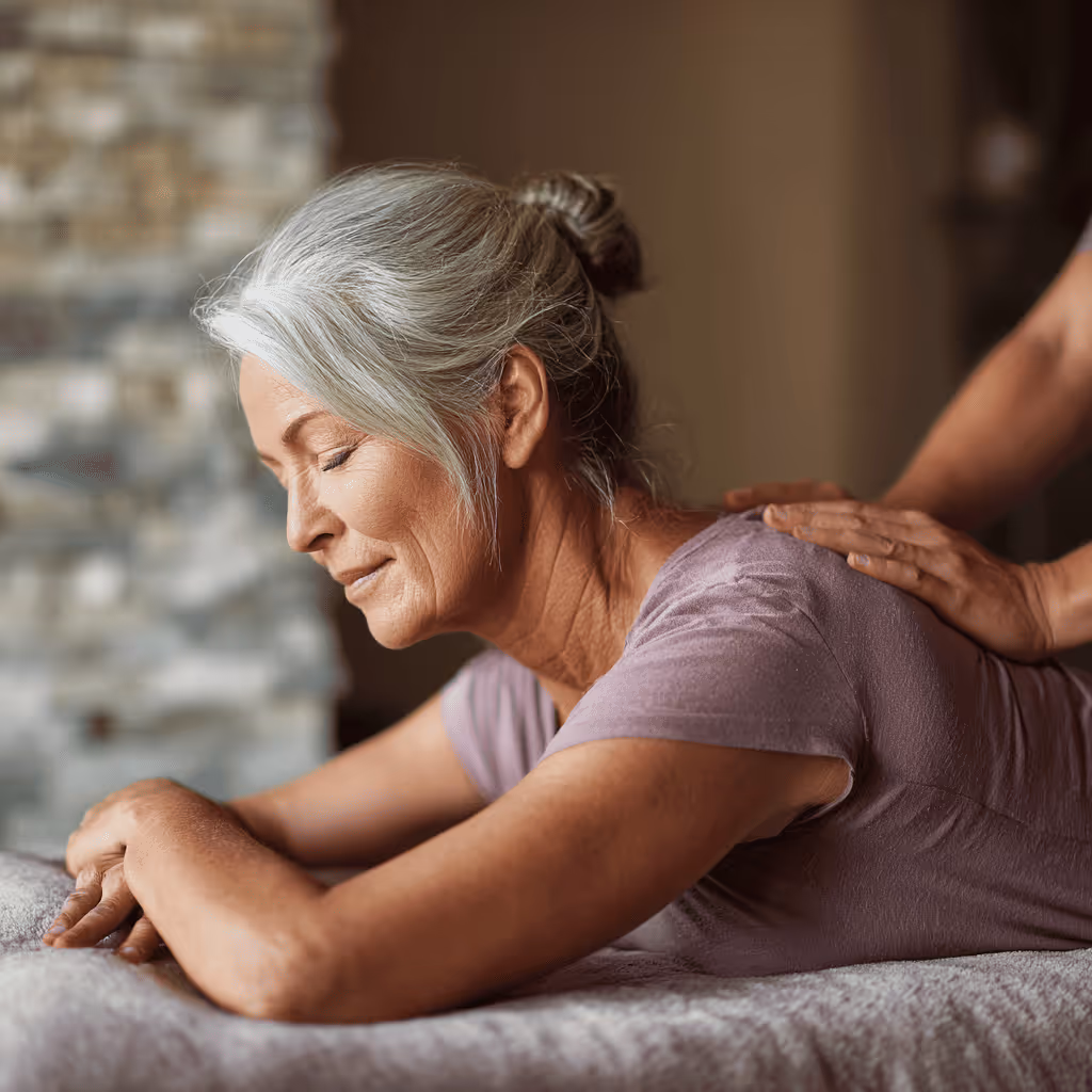 Older woman receiving therapeutic chiropractic massage for pain relief and relaxation.