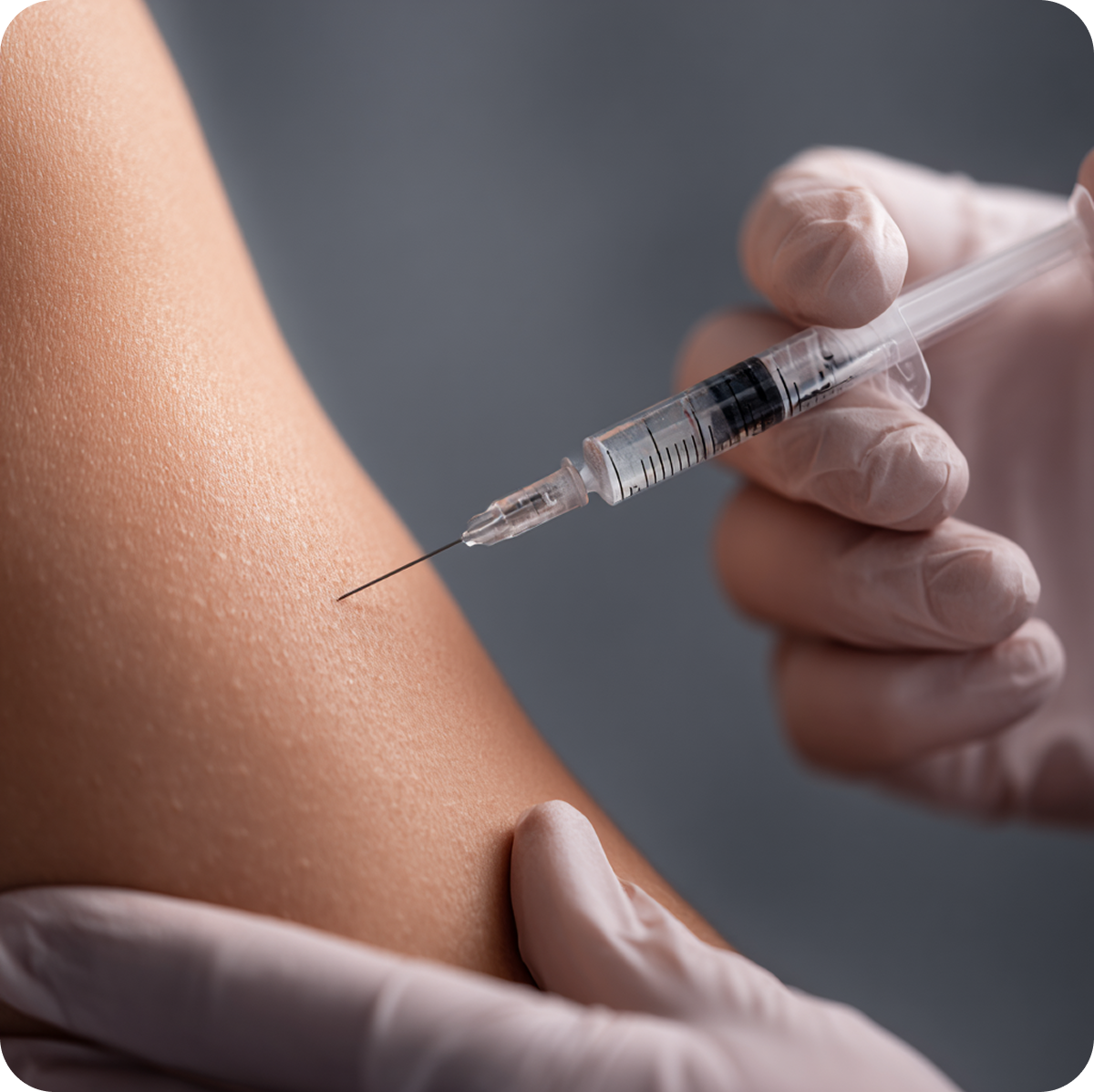 Close-up of a gloved hand administering an injection into an arm, representing peptide-based therapy at Apex Performance & Longevity
