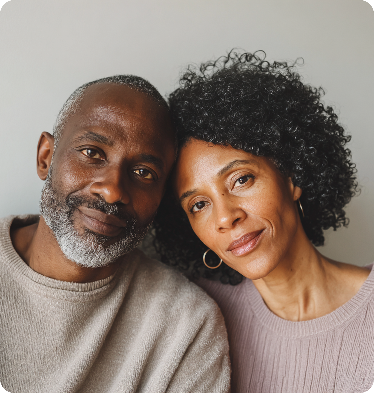 Portrait of a relaxed couple seated together, used to represent hormone replacement therapy care at Apex Performance & Longevity