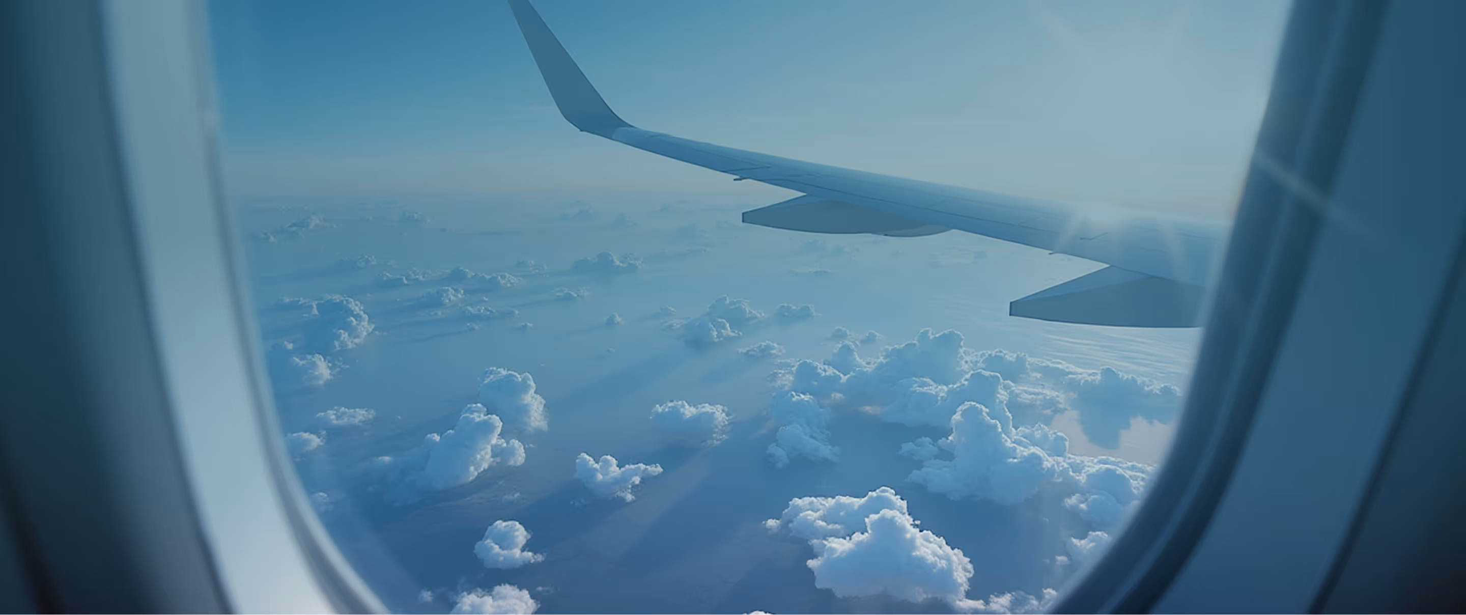 View of an aircraft wing from the window above the clouds