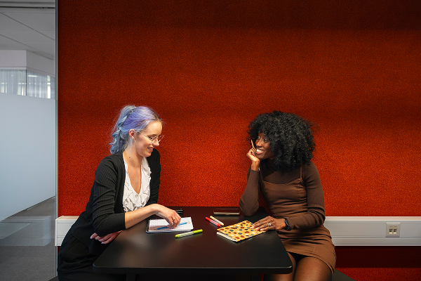 Two woman sitting down having a conversation