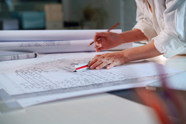 A person working on blueprint plans