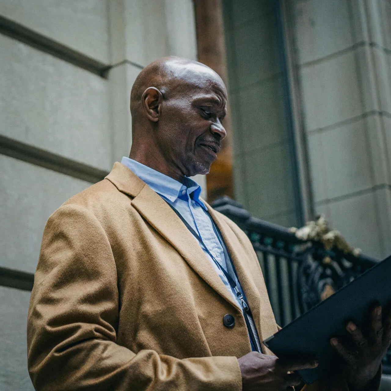 black businessman reading documents on street