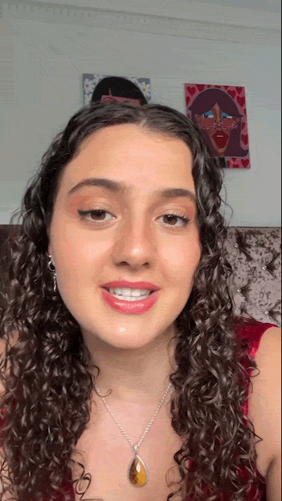 Headshot of a female artist with long, curly hair