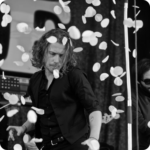 Artist performing on stage as confetti falls