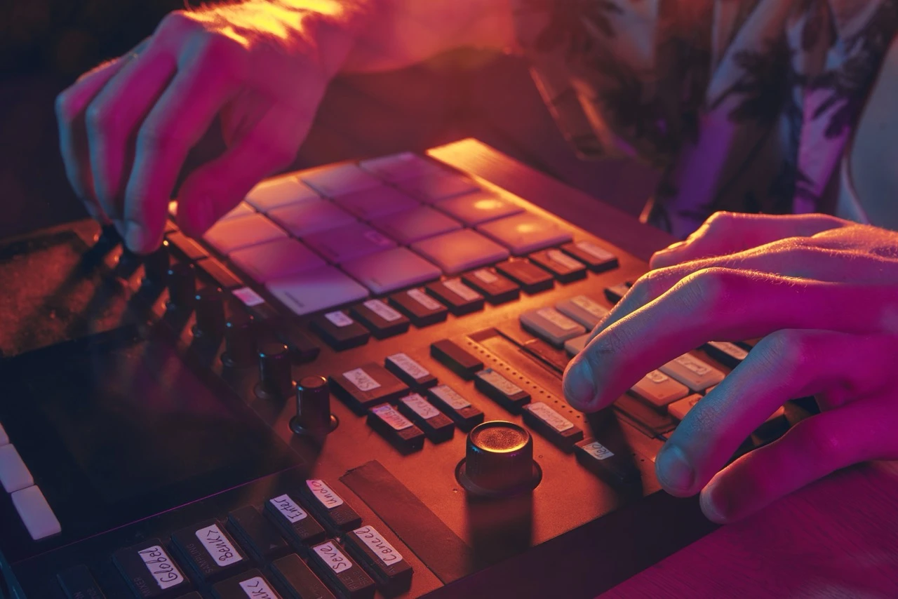 Close up of an artists hands using a mixing desk