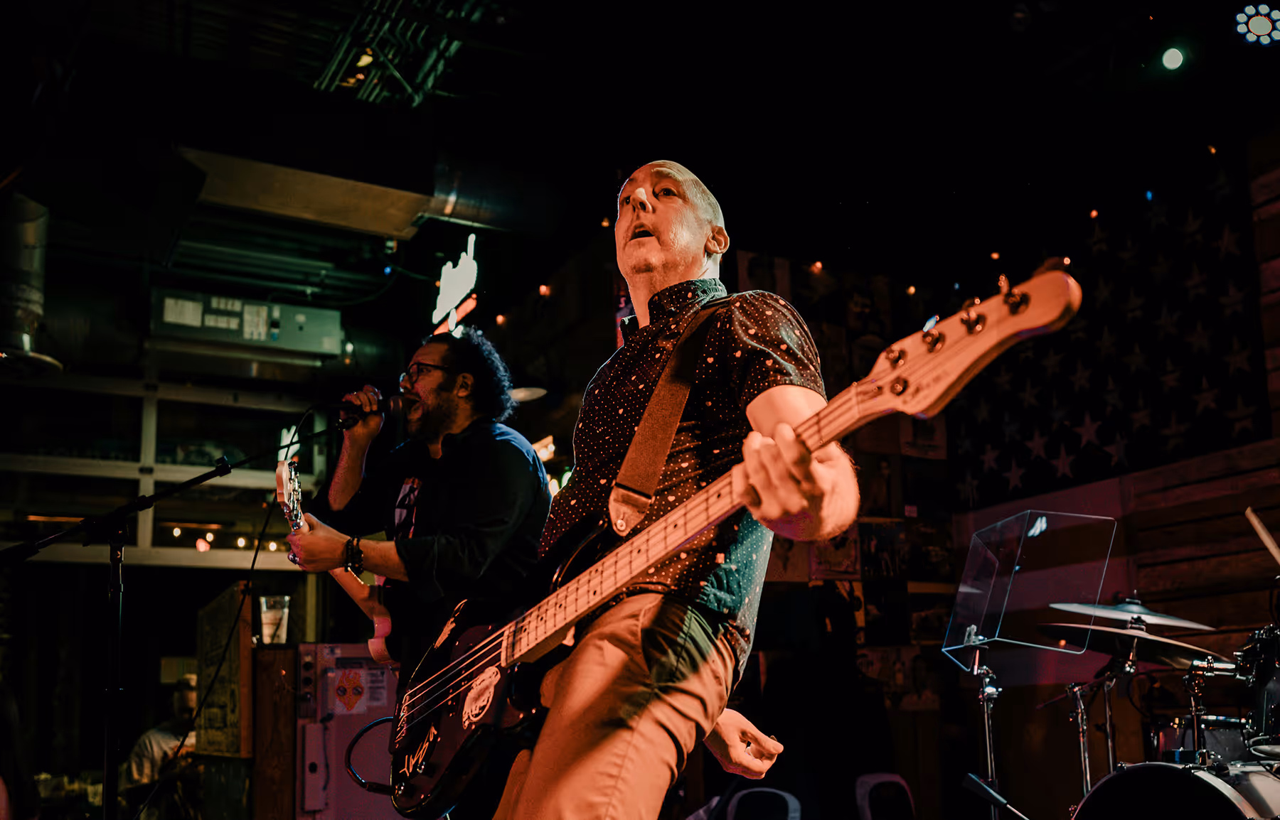 A man with guitar on stage
