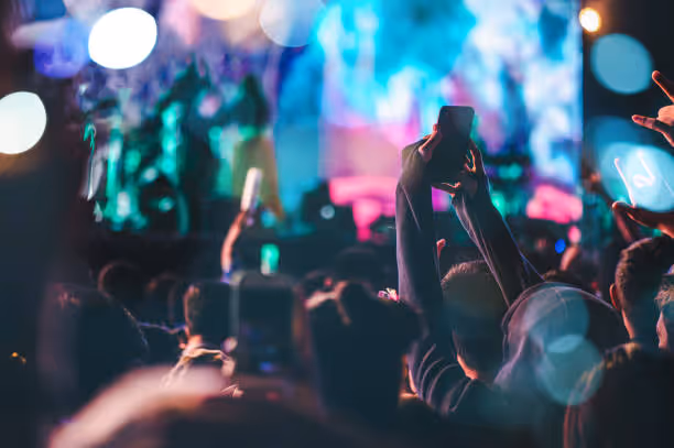 Picture of a crowd enjoying music and recording the experience with their phones 