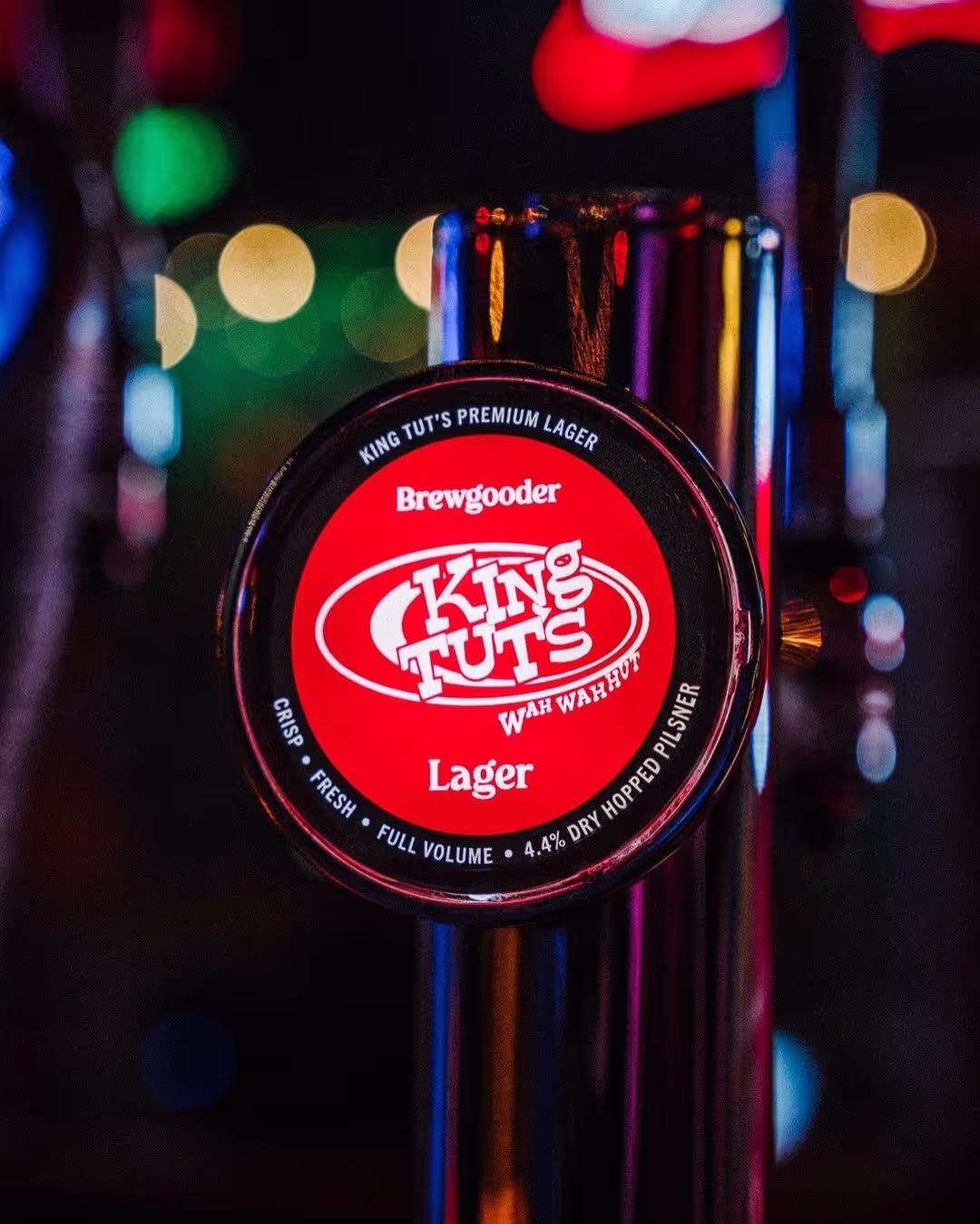 A close-up of a beer tap featuring the logo of a bar, showcasing its polished finish and inviting design