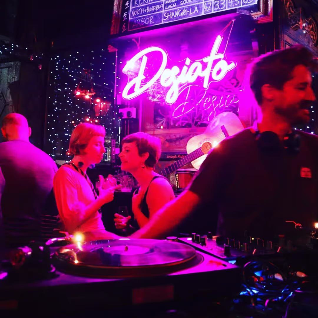 A close-up of a beer tap featuring the logo of a bar, showcasing its polished finish and inviting design