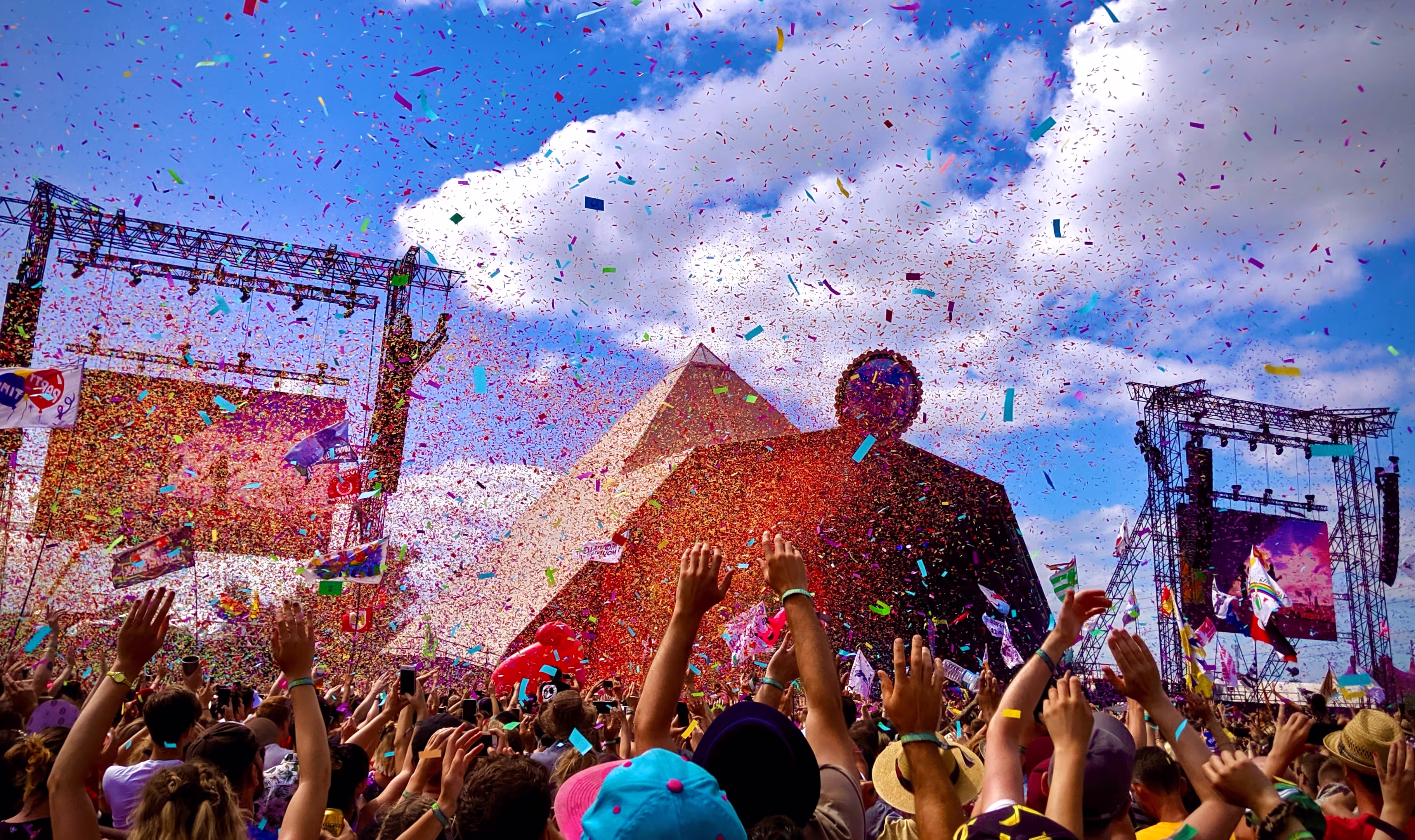 Colorful smoke billows into the air, creating a vibrant atmosphere at a lively festival celebration
