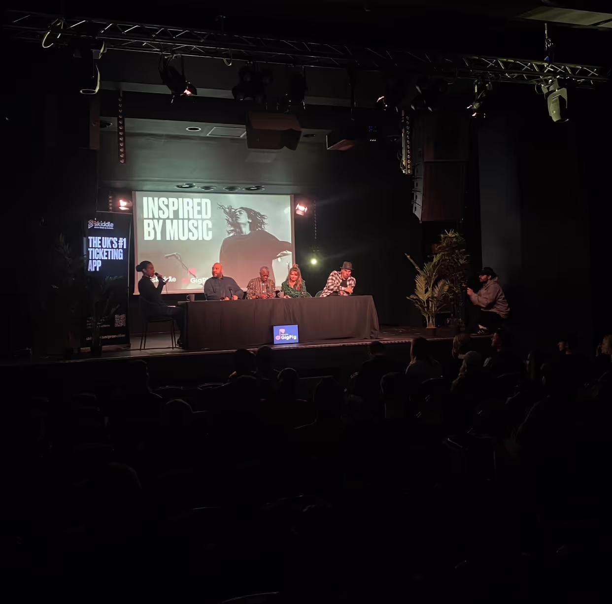 Several people gathered at a table, actively participating in discussion and sharing ideas in a communal atmosphere.