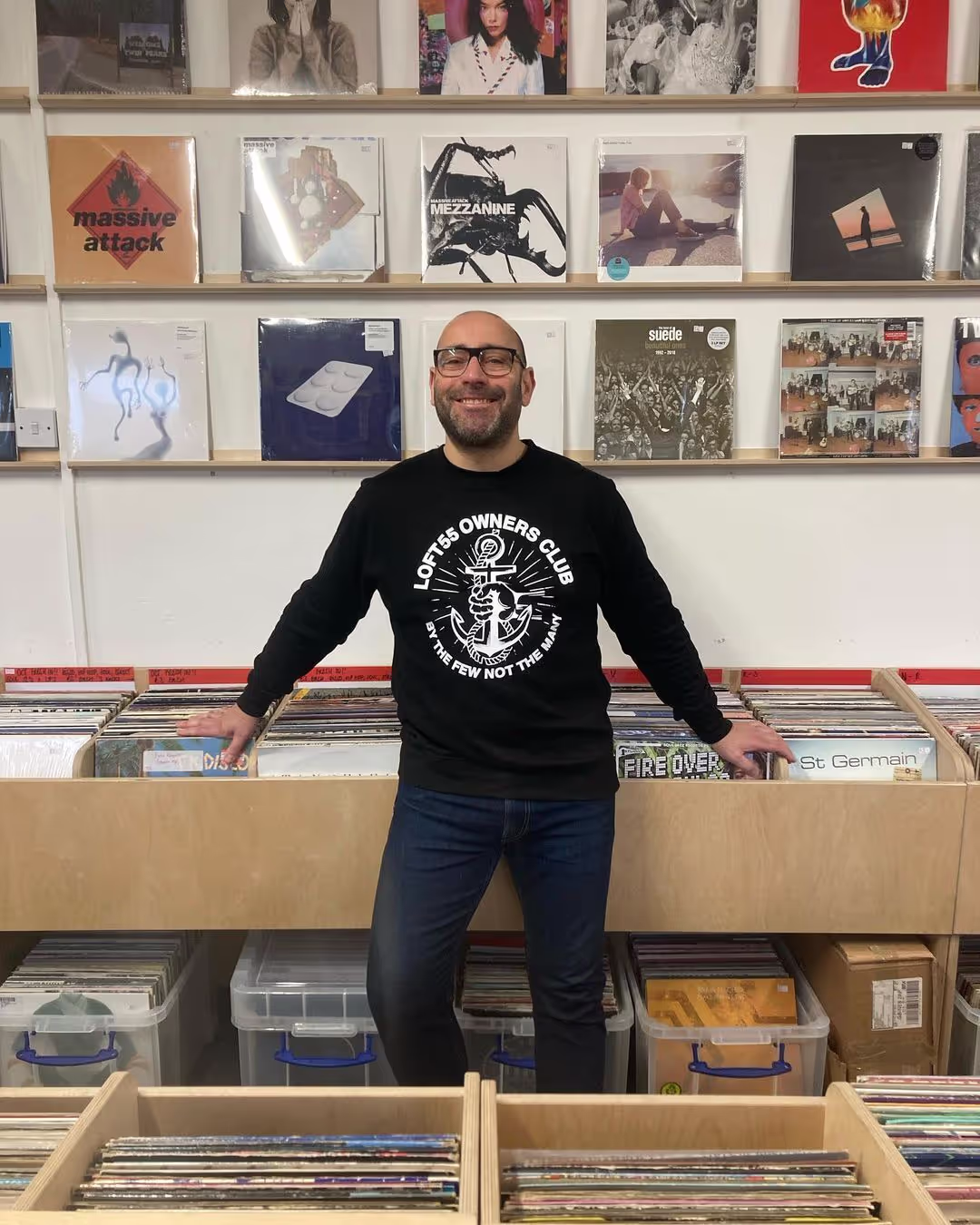 A group of individuals browsing through vinyl records in a vibrant record store, exploring various music genres