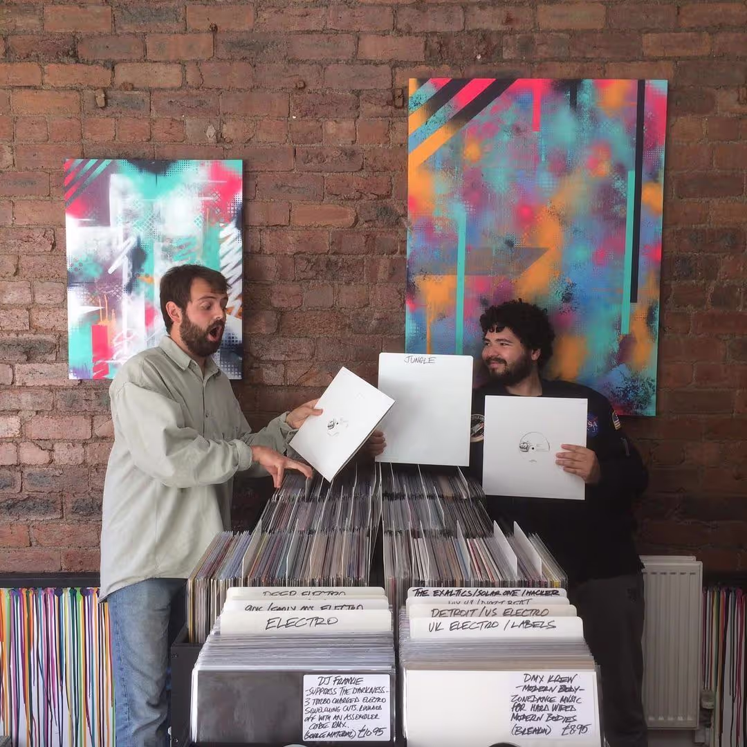 A busy shop interior featuring customers browsing and a computer on the counter