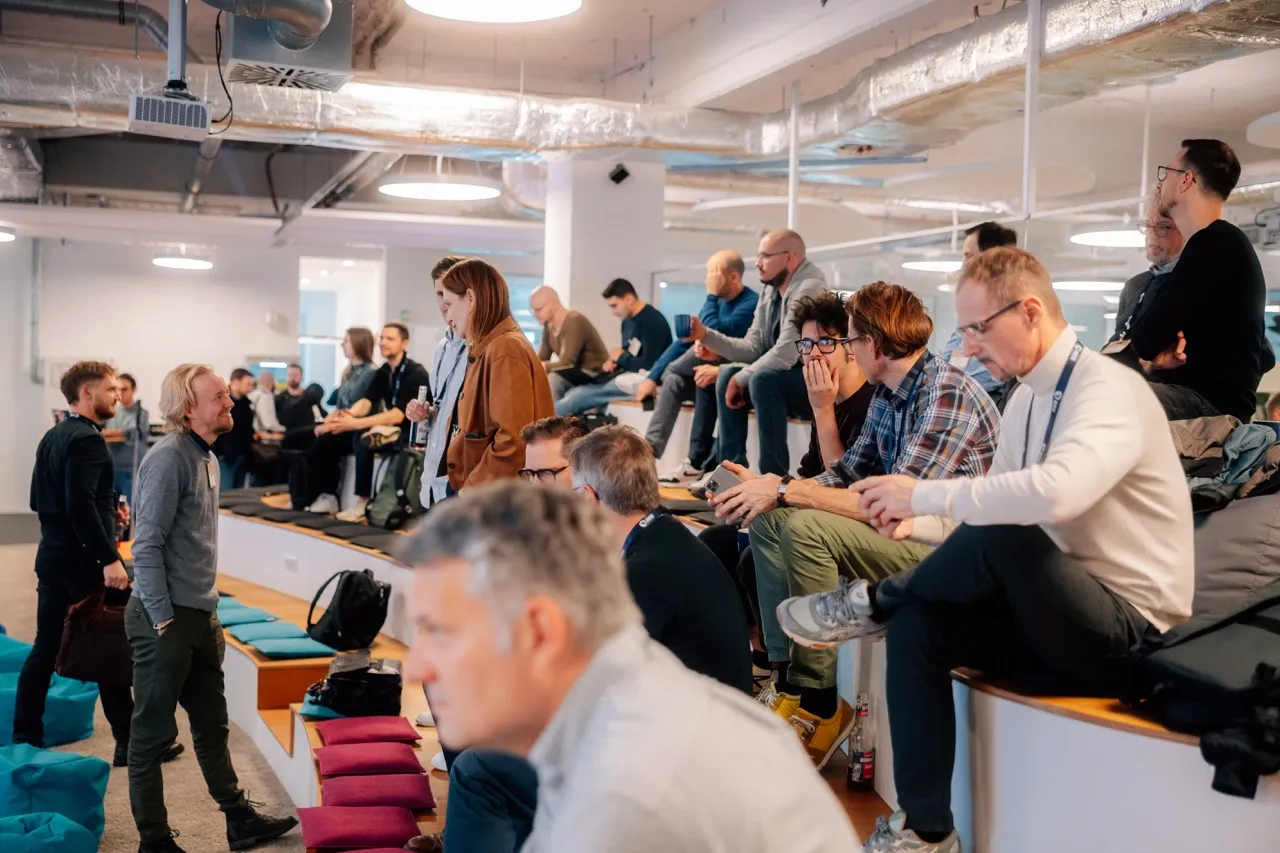two women smiling and talking at event