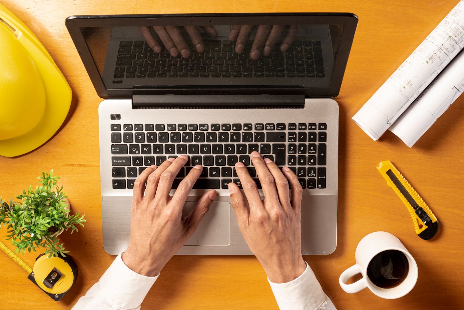 Content Marketing Tips: A laptop with typing fingers representation for showing repurpose of Old Content