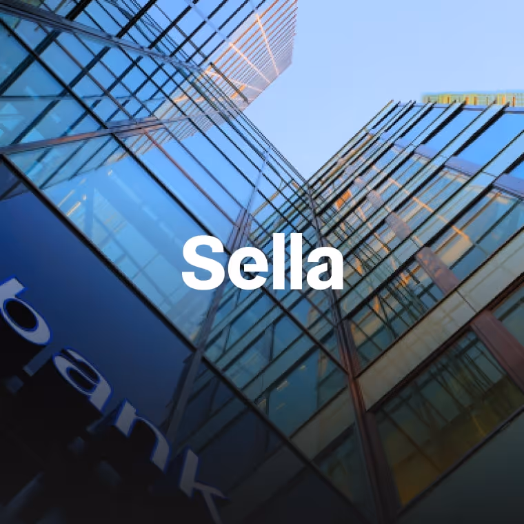 Upward view of modern glass office buildings with the word 'Sella' in white text at center.