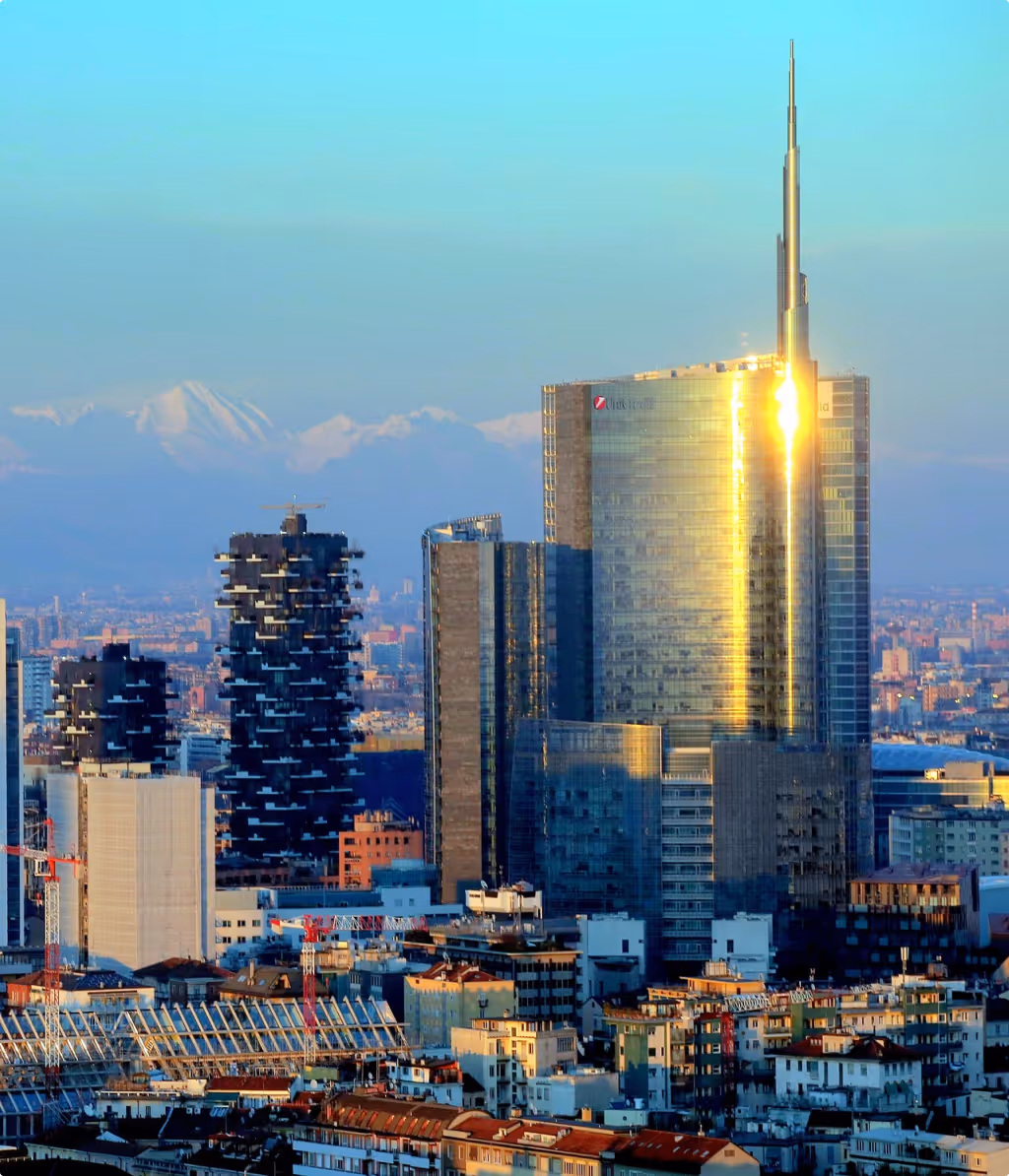 City skyline at sunset with modern skyscrapers.