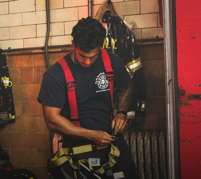 Firefighter putting on his gear