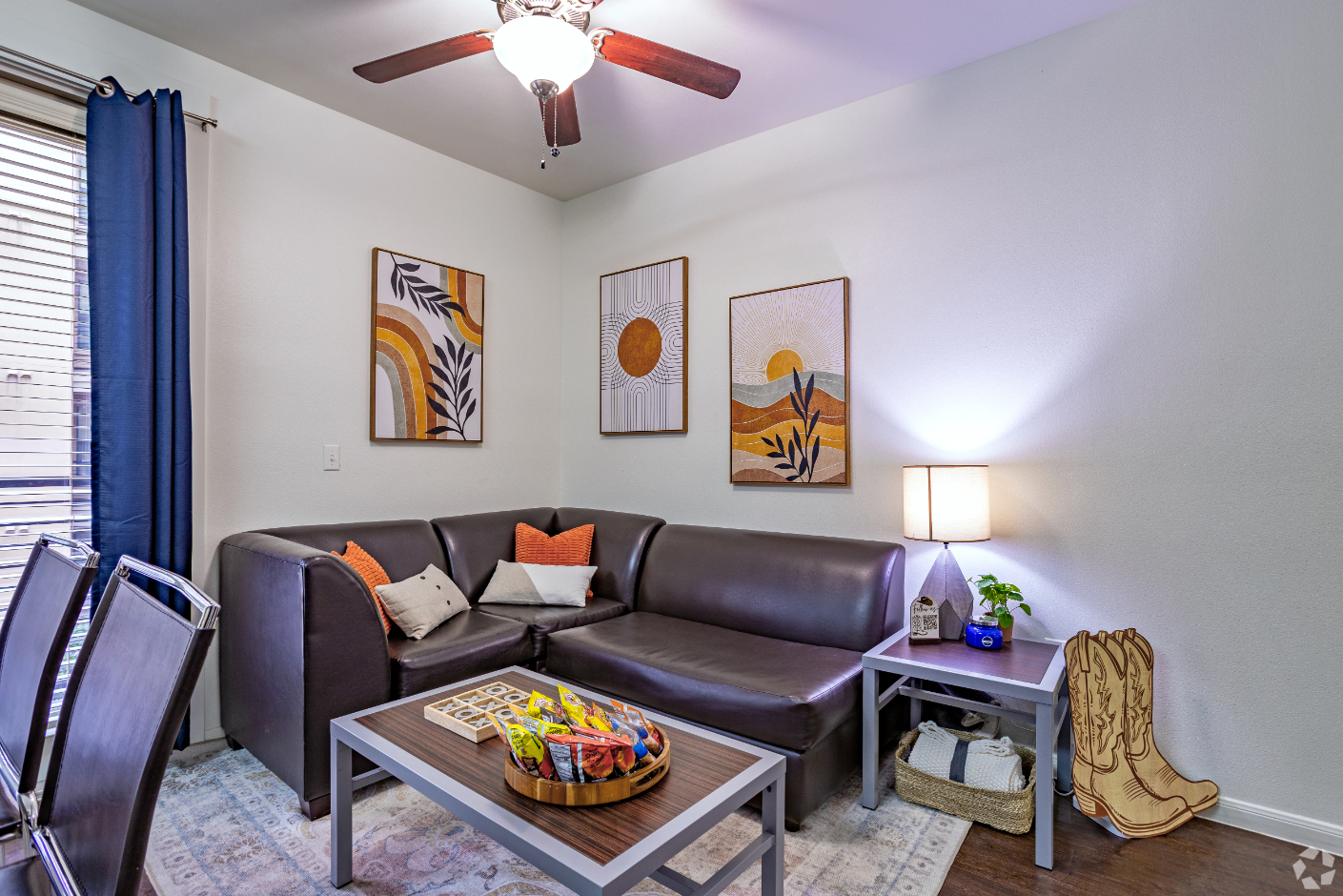 Living area with sofa, modern wall art, and coffee table with snacks 