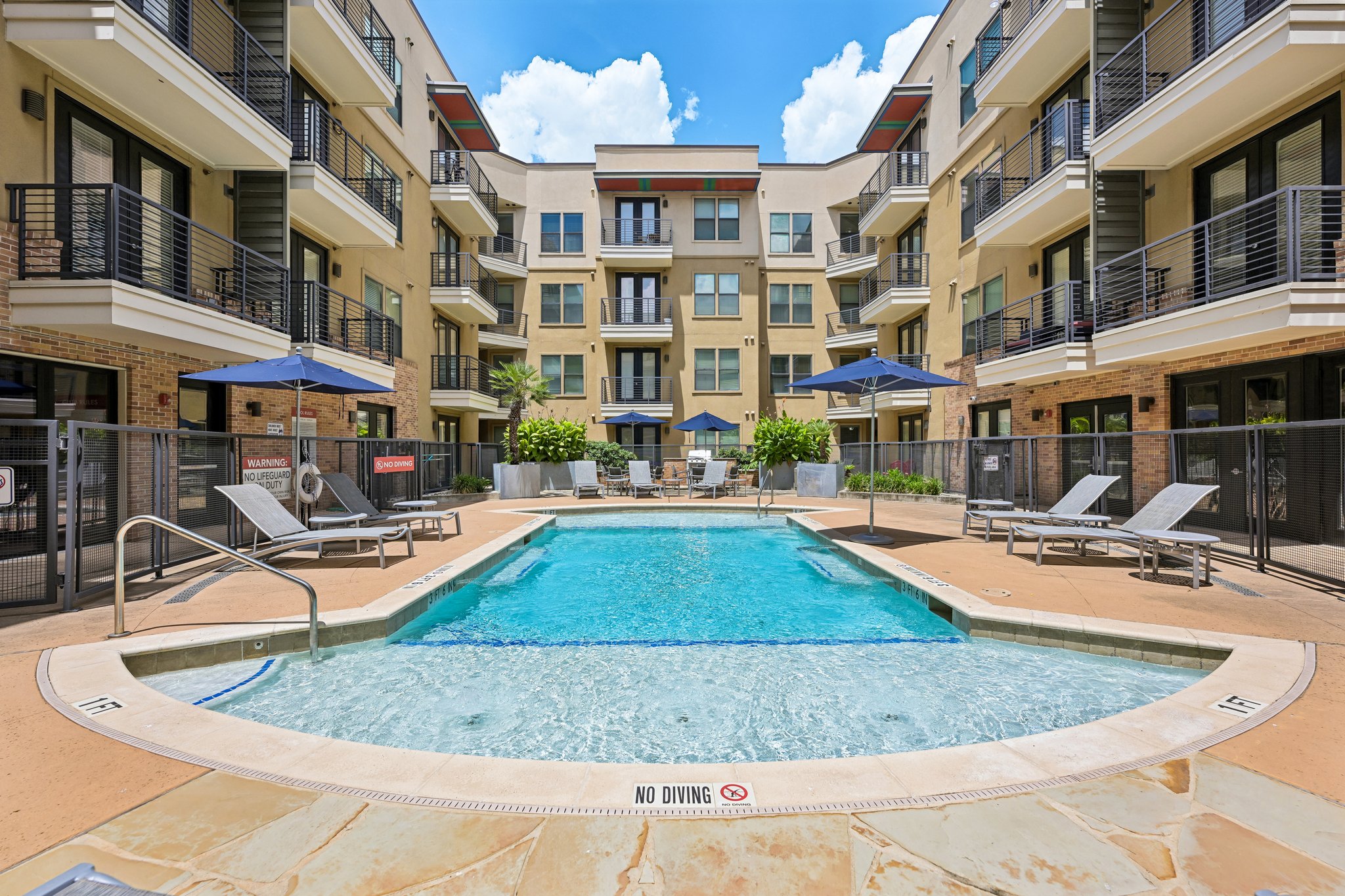 Pool with lounge chairs and umbrellas