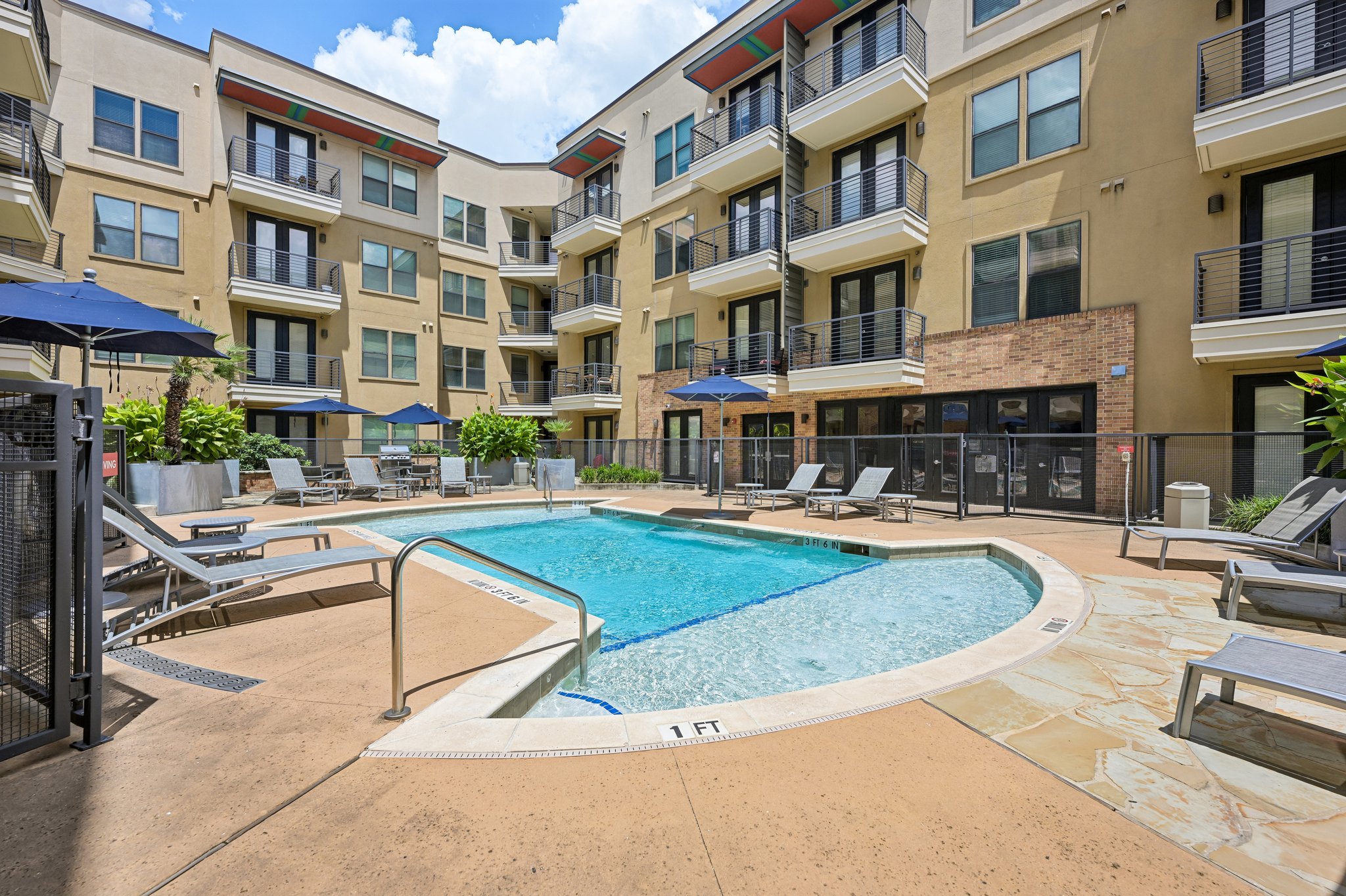Pool with lounge chairs and umbrellas