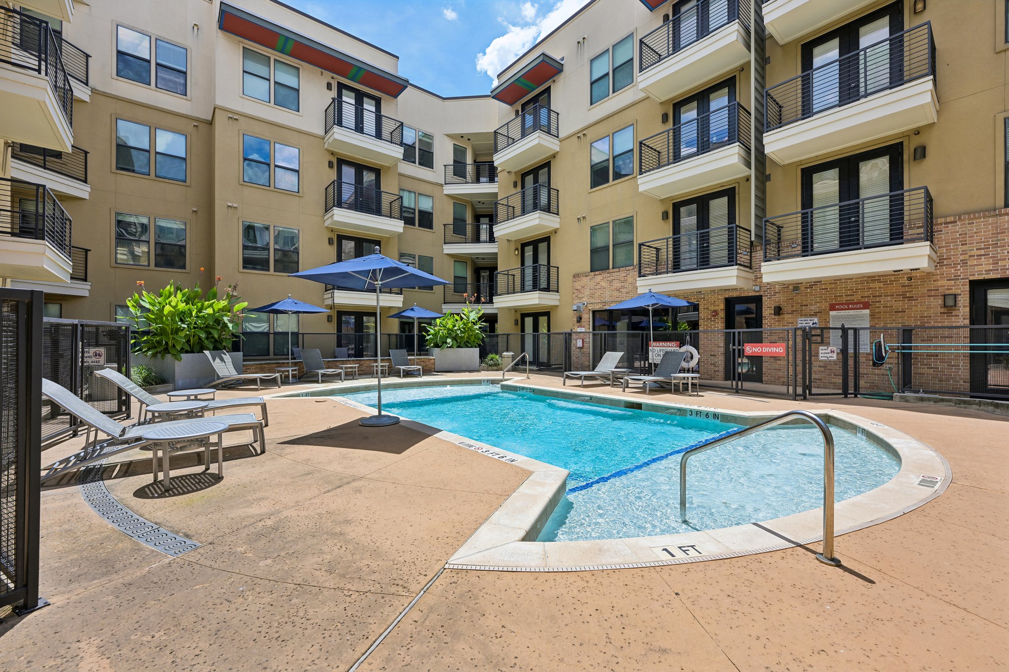 Pool with lounge chairs and umbrellas