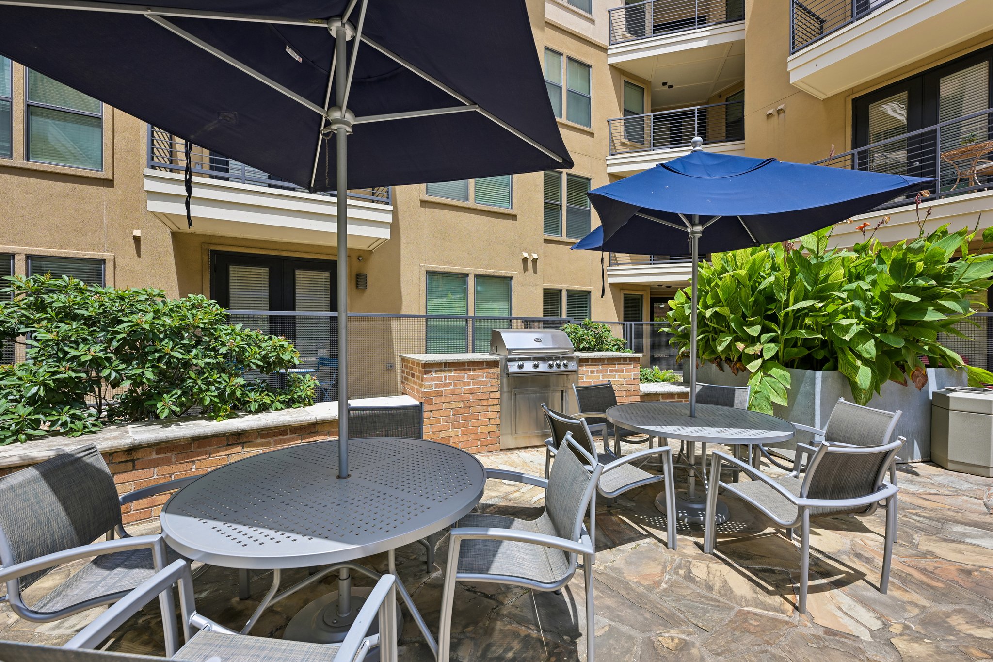 Bqq grills with tables and chairs with umbrellas