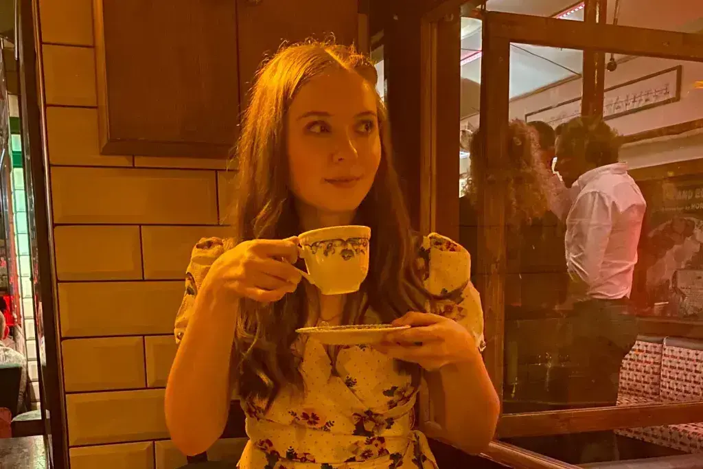 woman holding teacup and saucer