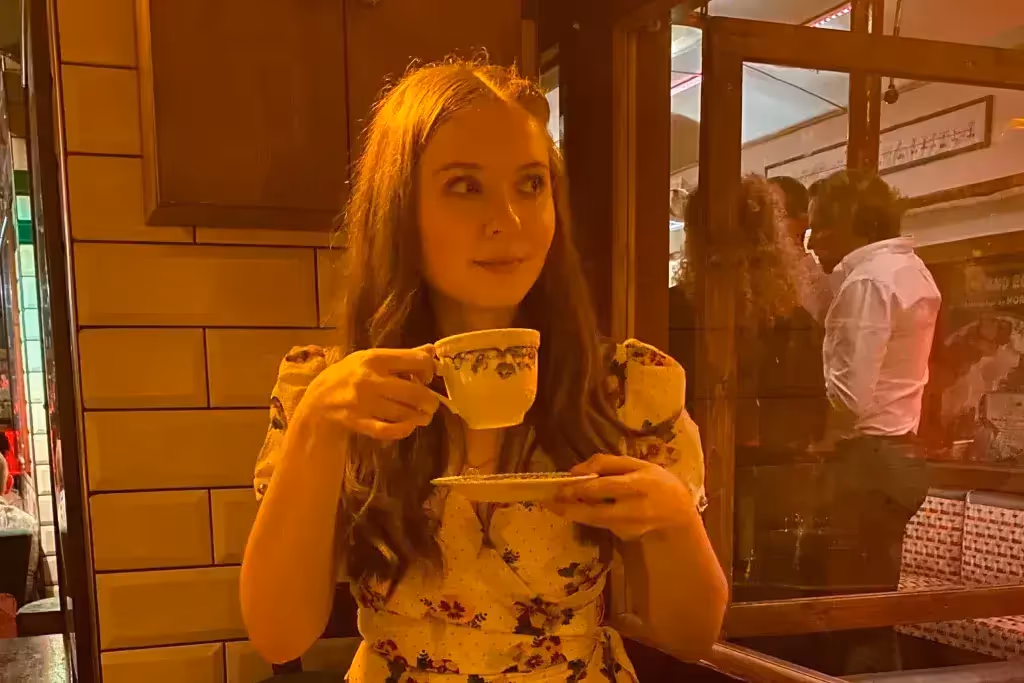 woman holding teacup and saucer