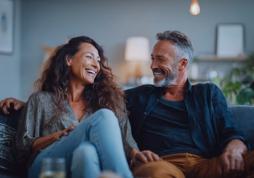 Couple laughing on a couch