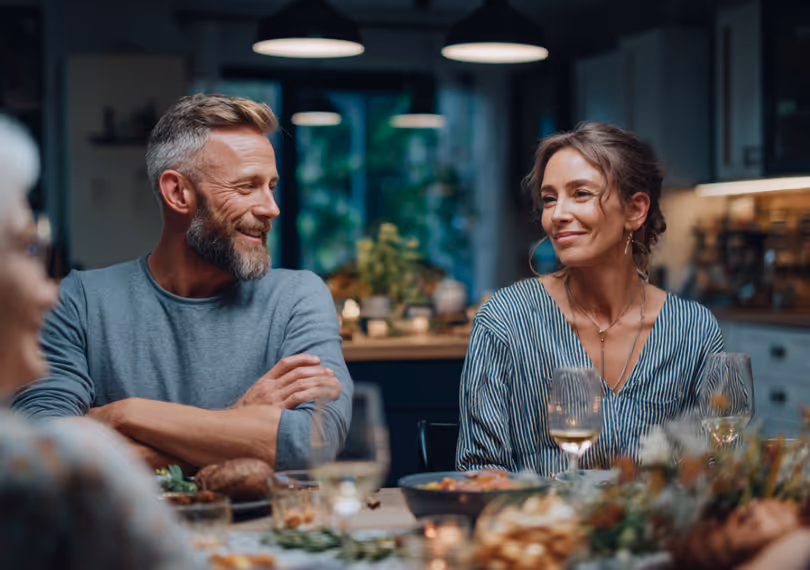 Couple having dinner with their family