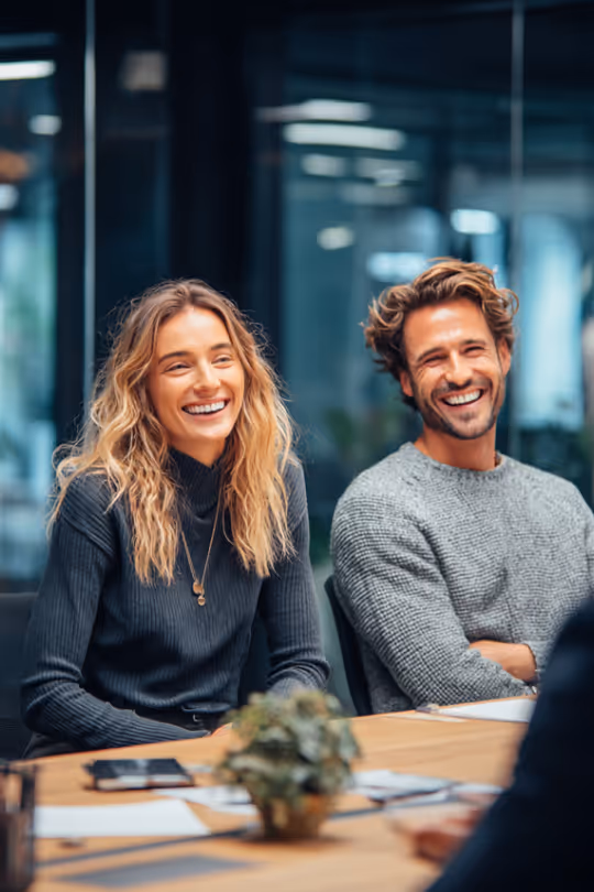 Millennial Couple Laughing in a meeting with an advisor
